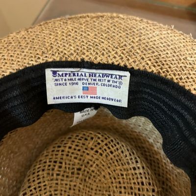 Sale Photo Thumbnail #11: Interior detail of a straw hat featuring a original Imperial Headwear Denver, Colorado tag attached to the inner black sweatband.