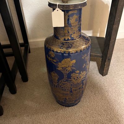 Sale Photo Thumbnail #99: Large cobalt blue Asian-style floor vase featuring gilt floral and decorative vessel motifs throughout.