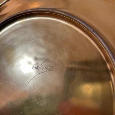 Sale Photo Thumbnail #63: Underside of a vintage brass plate or tray featuring an engraved Osborne signature.