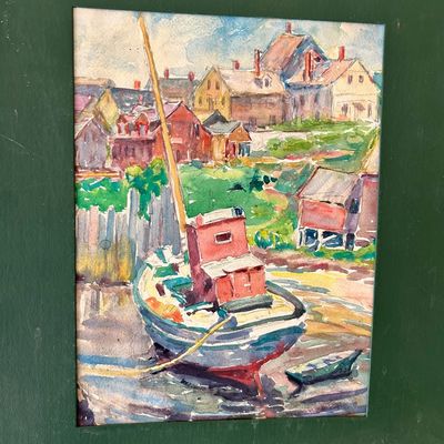 Sale Photo Thumbnail #144: Framed watercolor painting depicting a colorful harbor scene with fishing boats and coastal houses, set in a deep green mat.