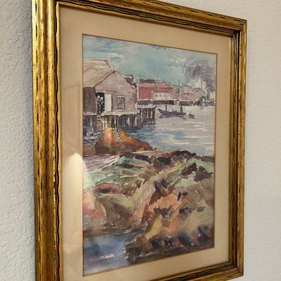 Sale Photo Thumbnail #58: Framed watercolor landscape painting depicting a coastal village with fishing shacks, presented in an ornate gilded wood frame.