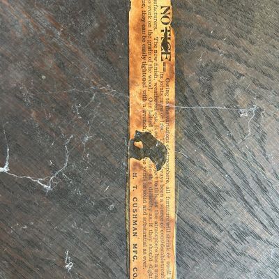 Sale Photo Thumbnail #116: Vintage H. T. Cushman Mfg. Co. paper manufacturer label attached to dark-stained wood furniture.