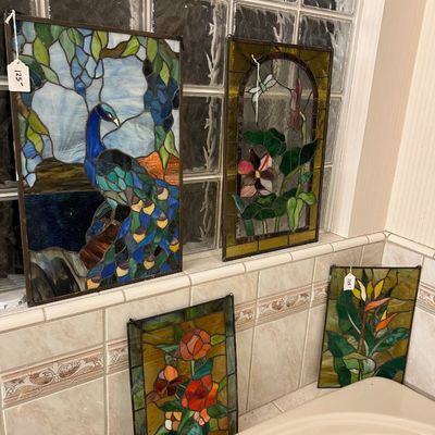 Sale Photo Thumbnail #47: Collection of four framed stained glass suncatcher panels featuring peacock, dragonfly, rose, and bird of paradise designs.