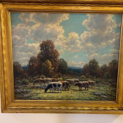 Sale Photo Thumbnail #3: Framed pastoral oil painting depicting cattle grazing in a field under a cloudy sky, housed in a molded gilt frame.