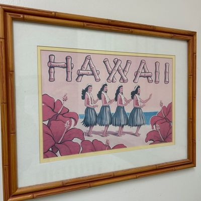 Sale Photo Thumbnail #6: Framed vintage Hawaiian-themed art print featuring hula dancers, hibiscus flowers, and bamboo lettering, housed in a faux bamboo wooden frame.