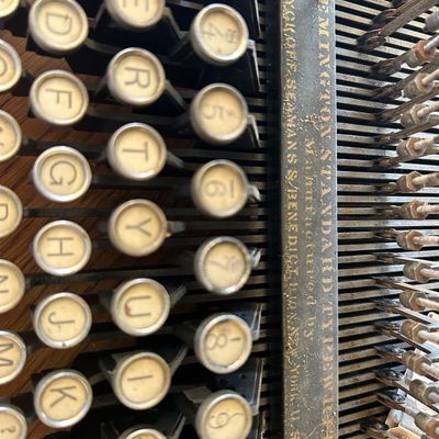 Sale Photo Thumbnail #111: Vintage Remington Standard typewriter detailing circular keys and exposed mechanical typebar components.