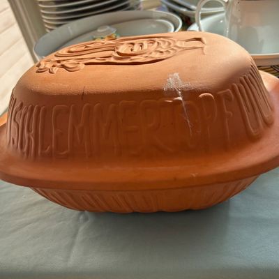 Sale Photo Thumbnail #108: Vintage Schlemmertopf terracotta clay baker with embossed lid and decorative fish motif.
