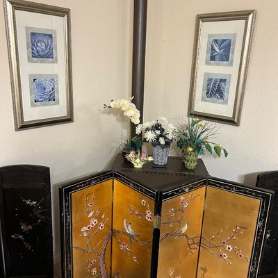 Sale Photo Thumbnail #82: Four-panel vintage Asian table screen with a gold-leaf ground, hand-painted cherry blossoms, and birds, positioned in front of a stove pipe.
