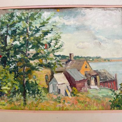 Sale Photo Thumbnail #164: Impressionist oil landscape painting depicting coastal buildings and lush foliage, mounted in a simple pale frame.