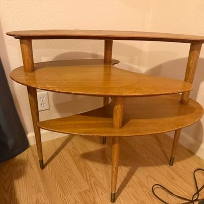 Sale Photo Thumbnail #193: Mid-century modern three-tier kidney-shaped wood side table with brass-tipped tapered legs.
