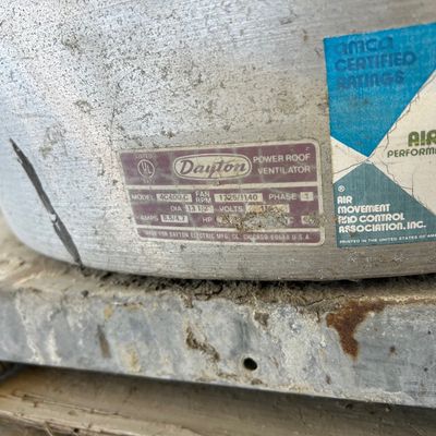 Sale Photo Thumbnail #134: Close-up of a Dayton power roof ventilator model 4C400 C, displaying manufacturer and AMCA certification labels on its metal housing.