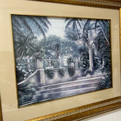 Sale Photo Thumbnail #9: Framed artwork depicting a tropical courtyard scene with stone steps and palm trees, set in an ornate gilded frame.