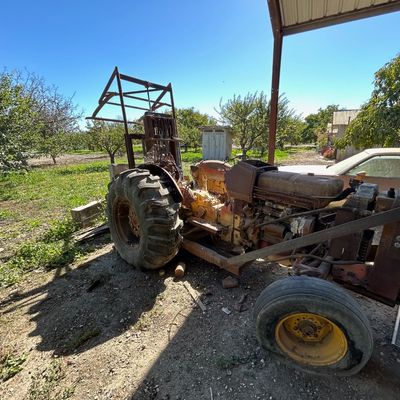 Sale Photo Thumbnail #118: Vintage industrial forklift tractor showing heavy rust, weathering, and wear, suitable for parts or restoration.