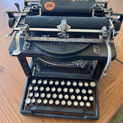 Sale Photo Thumbnail #109: Antique Remington Standard No. 6 manual typewriter, circa late 1890s to early 1900s, featuring an open-frame design with original gold lettering and round glass-topped keys.