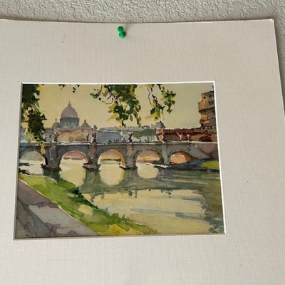 Sale Photo Thumbnail #140: Matted watercolor painting depicting the Ponte Sant'Angelo and St. Peter's Basilica in Rome, pinned to a wall.