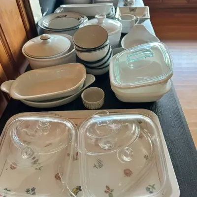 Sale Photo Thumbnail #23: Large collection of white ceramic, porcelain, and glass cookware, including casserole dishes with lids, mixing bowls, and baking pans.