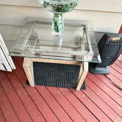 Sale Photo Thumbnail #10: Contemporary glass-top side table with a textured stone-look frame, topped with a decorative clear glass centerpiece centerpiece bowl containing green filler.