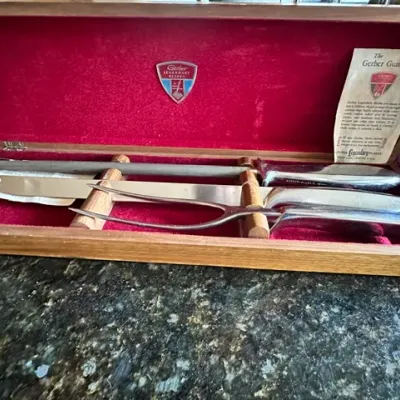 Sale Photo Thumbnail #21: Vintage Gerber Legendary Blades carving set in original velvet-lined wooden presentation box, including carving knife, fork, and sharpening steel.
