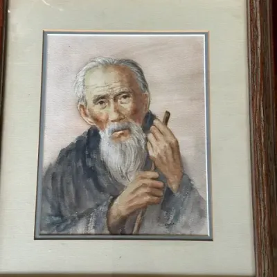 Sale Photo Thumbnail #38: Framed watercolor portrait depicting an elderly East Asian man with a long white beard holding a staff, presented in a matted wooden frame.