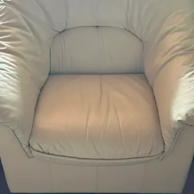 Sale Photo Thumbnail #26: Contemporary off-white leather armchair with plush pillowing and metal feet.