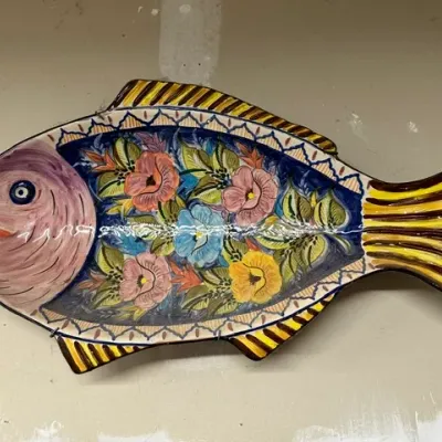 Sale Photo Thumbnail #2: Hand-painted Mexican Talavera pottery fish platter featuring a vibrant floral pattern on the body and striped fins.