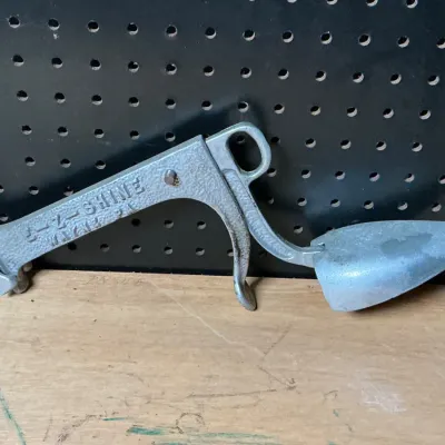 Sale Photo Thumbnail #186: E-Z-Shine wall-mounted aluminum shoe shine bracket holder.