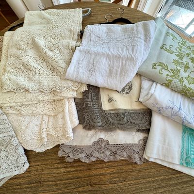 Fine linens, crochet, tatting, lace, Quaker lace (picot edge). A small sample of the many tablecloths of all styles and colors.
