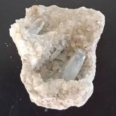 Natural quartz crystal geode cluster featuring prominent pale blue celestite or quartz points.