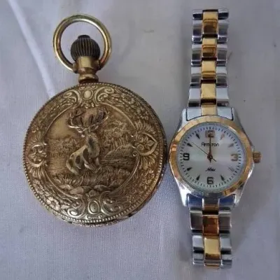 Gold-tone pocket watch featuring a relief engraving of a stag alongside a modern two-tone Armitron Now wrist watch.