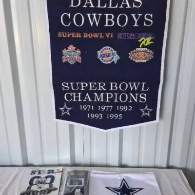 Dallas Cowboys Super Bowl Champions commemorative felt banner hanging above two magazines and a rally towel.