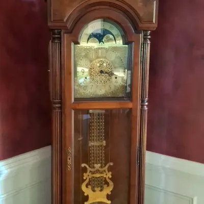 Howard Miller Grandfather Clock with Moon Phase Dial, Brass Pendulum & Wood Case
