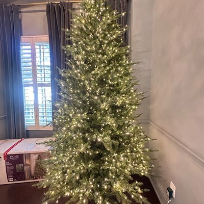 Sale Photo Thumbnail #9: Tall pre-lit artificial Christmas tree fully assembled with warm white lights, displayed with its original Home Decorators Collection box.
