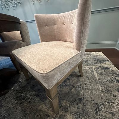 Sale Photo Thumbnail #105: Modern curved accent chair in light beige velvet upholstery with button-tufted back detailing and light wood legs.