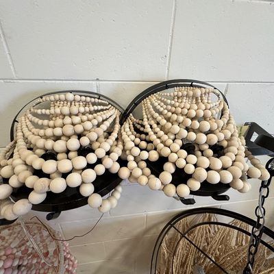 Sale Photo Thumbnail #126: Pair of modern bohemian light fixtures with black metal frames draped in natural light wood beads.