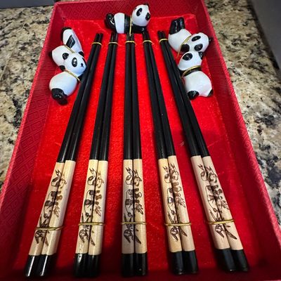 Sale Photo Thumbnail #83: Set of five panda-themed wooden chopstick pairs with five matching ceramic panda chopstick rests, housed in a red gift box.