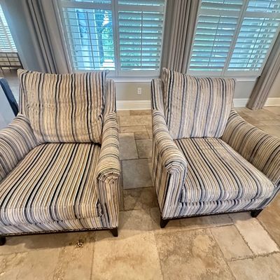 Sale Photo Thumbnail #14: Pair of contemporary upholstered armchairs featuring neutral vertical stripes and dark wood trim.