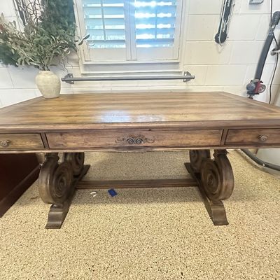Sale Photo Thumbnail #92: Traditional wooden executive writing desk featuring carved scroll legs, three storage drawers, and a planked top finish.