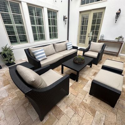 Sale Photo Thumbnail #17: Contemporary outdoor wicker patio furniture set, including a three-seat sofa, two armchairs, two ottomans, a coffee table, and an end table with beige cushions.