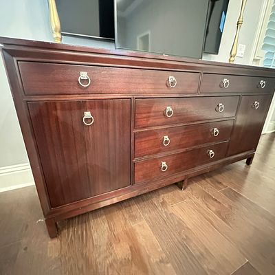 Sale Photo Thumbnail #101: Traditional mahogany triple dresser featuring multiple drawers, side cabinet doors, and brass ring pull hardware.