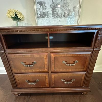Sale Photo Thumbnail #65: Traditional dark cherry media chest featuring four drawers with brass bail handles, open media shelf, and carved fluted details.