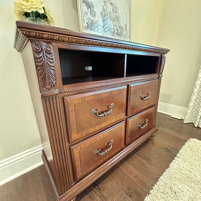 Sale Photo Thumbnail #66: Traditional wood media console dresser featuring carved accents, open media cubbies, and four drawers with bail handles.