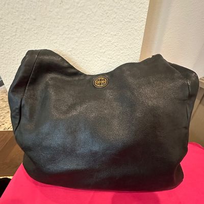 Sale Photo Thumbnail #54: Black leather Tory Burch hobo bag featuring a gold-tone logo medallion on the front.
