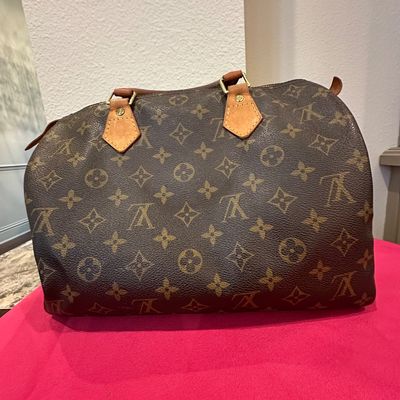 Sale Photo Thumbnail #55: Louis Vuitton Monogram Speedy handbag with natural cowhide leather trim and brass hardware, showing moderate patina and wear.