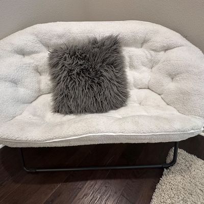 Sale Photo Thumbnail #80: Modern white faux-sherpa double papasan-style loveseat with a black metal frame, paired with a charcoal grey shag accent pillow.