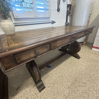 Sale Photo Thumbnail #93: Traditional style dark wood executive desk featuring decorative carved scroll base, inset top panel, and front storage drawers.