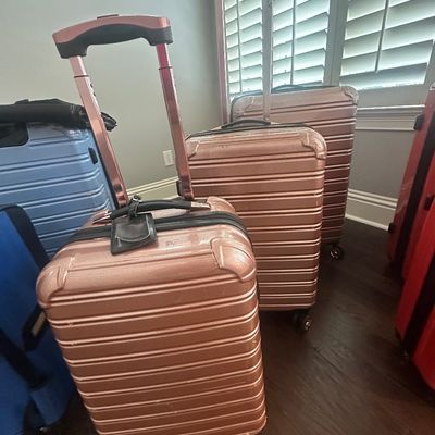 Sale Photo Thumbnail #76: Set of three rose gold iFLY hardside rolling suitcases, displayed alongside additional luggage options.