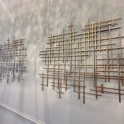 Sale Photo Thumbnail #106: Pair of mid-century modern metal grid wall sculptures in a brass-tone finish.