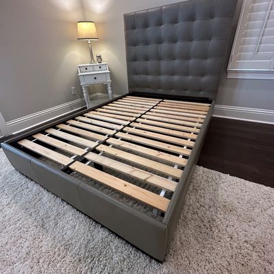 Sale Photo Thumbnail #78: Modern platform bed frame upholstered in grey faux leather, featuring a tall grid-tufted headboard and wooden support slats.
