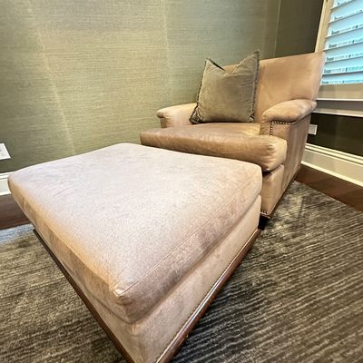 Sale Photo Thumbnail #112: Contemporary plush upholstered armchair and matching oversized ottoman, featuring nailhead trim details and an accent pillow.