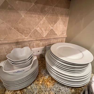 Sale Photo Thumbnail #38: Collection of white ceramic dinnerware, including stacked plates, bowls, and a CorningWare Blue Cornflower baking dish.